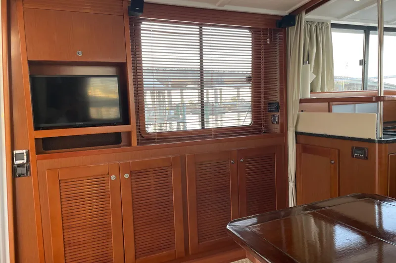 Slide: The Image of Interior of 2013 Beneteau Swift Trawler 44 with wood paneling and TV. - 19