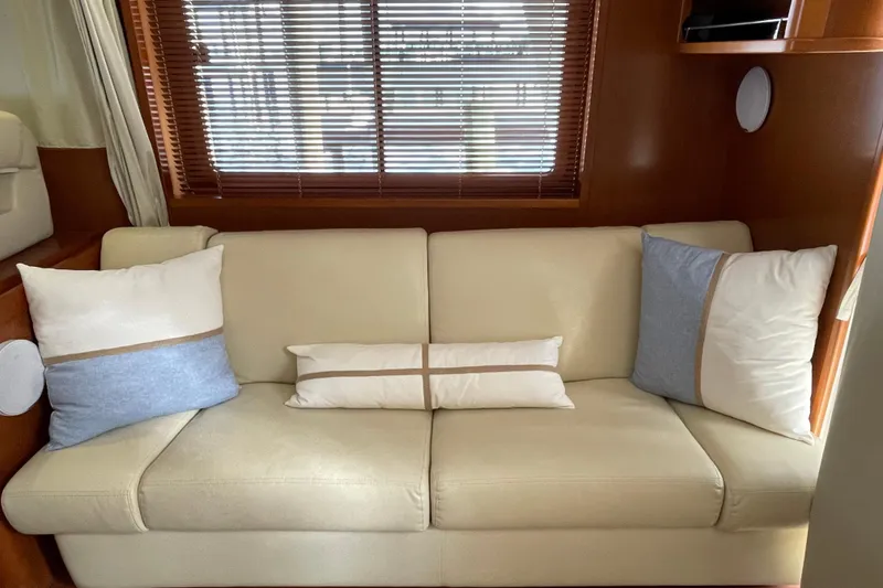 Slide: The Image of Luxurious interior of 2013 Beneteau Swift Trawler 44 with beige sofa and decorative pillows. - 20
