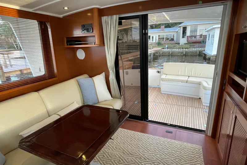 Slide: The Image of Interior of 2013 Beneteau Swift Trawler 44 with cozy seating and wooden finishes. - 22