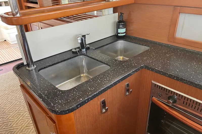 Slide: The Image of Galley kitchen in 2013 Beneteau Swift Trawler 44 with dual sinks and oven. - 25