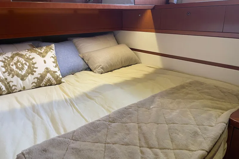 Slide: The Image of Cozy cabin bed in 2013 Beneteau Swift Trawler 44 with decorative pillows. - 33