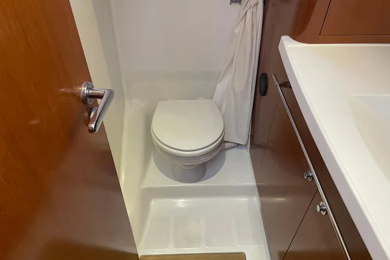 Slide: The Image of Bathroom interior of 2013 Beneteau Swift Trawler 44, featuring a compact toilet and sink. - 35