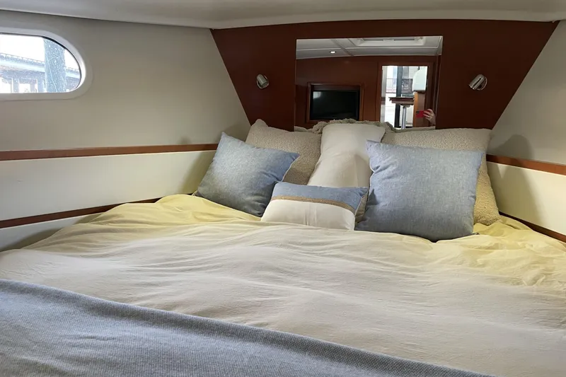 Slide: The Image of Cozy bedroom interior of 2013 Beneteau Swift Trawler 44 with plush pillows and soft lighting. - 36