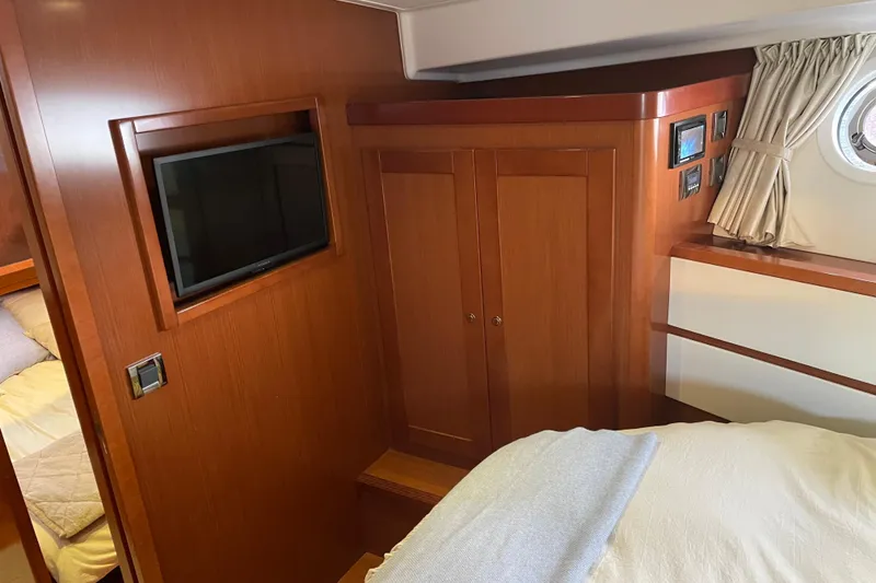 Slide: The Image of Interior of 2013 Beneteau Swift Trawler 44 with wood paneling and mounted TV. - 38