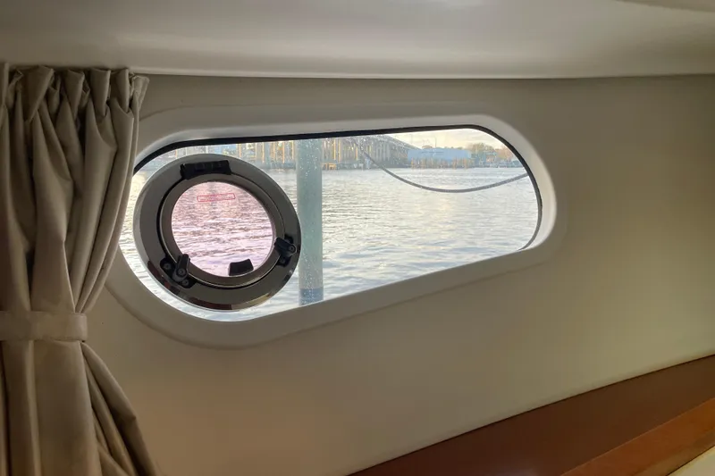 Slide: The Image of Porthole view from 2013 Beneteau Swift Trawler 44, overlooking serene waters. - 41