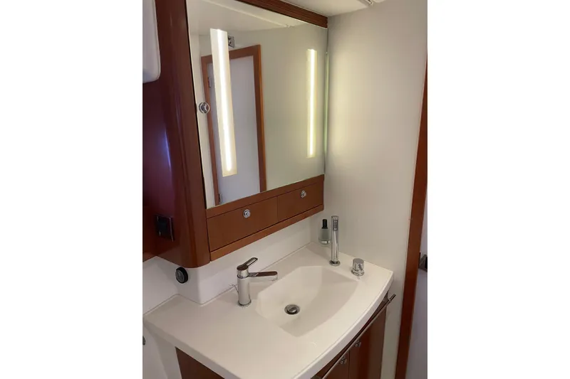 Slide: The Image of Modern bathroom vanity in 2013 Beneteau Swift Trawler 44, featuring sleek sink and mirror. - 44