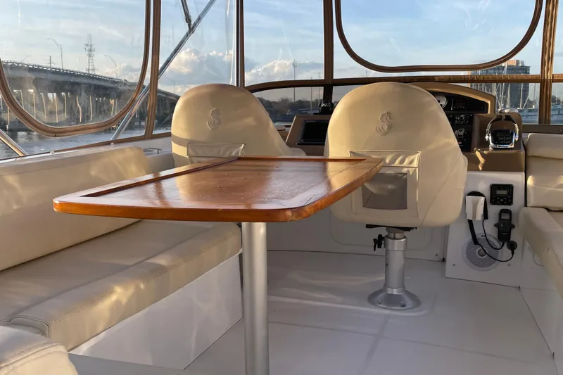 Slide: The Image of Interior of 2013 Beneteau Swift Trawler 44 with seating and wooden table. - 47