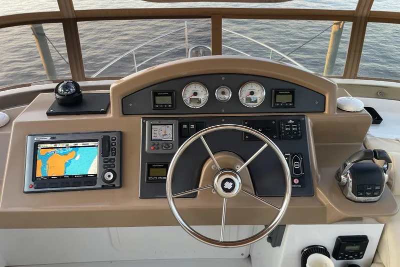 Slide: The Image of Helm of 2013 Beneteau Swift Trawler 44 with navigation equipment and steering wheel. - 48