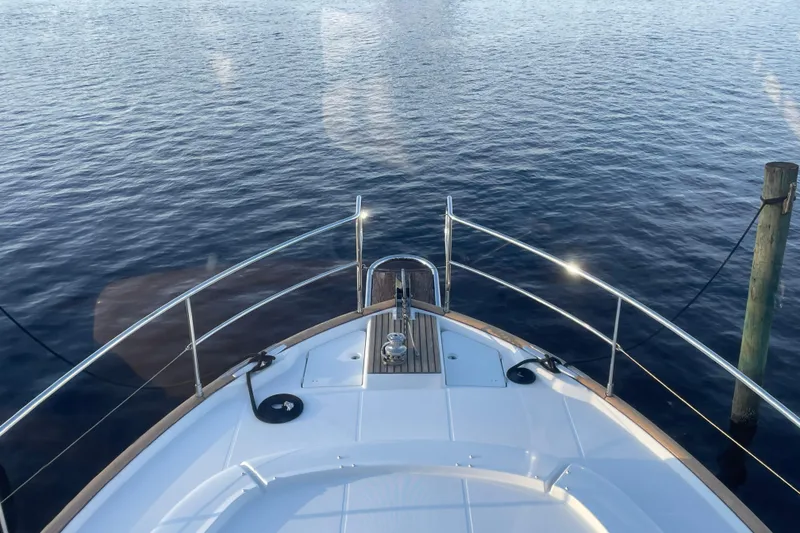 Slide: The Image of Bow view of 2013 Beneteau Swift Trawler 44 on calm water. - 49