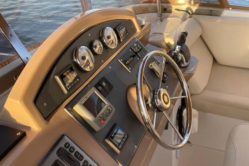 Slide: The Image of Helm of 2013 Beneteau Swift Trawler 44 with steering wheel and control panel. - 50