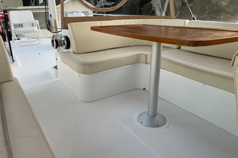 Slide: The Image of 2013 Beneteau Swift Trawler 44 interior with cushioned seating and wooden table. - 53