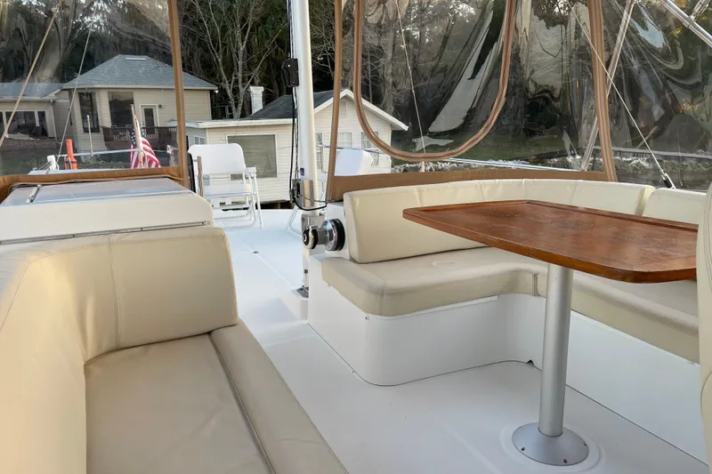 Slide: The Image of 2013 Beneteau Swift Trawler 44 interior with beige seating and wooden table. - 54