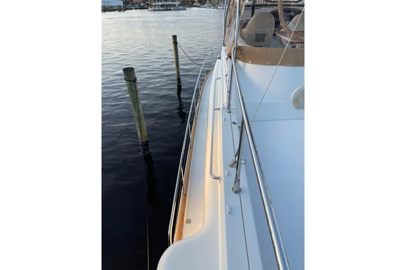 Slide: The Image of 2013 Beneteau Swift Trawler 44 docked, showcasing sleek deck and railing design. - 58