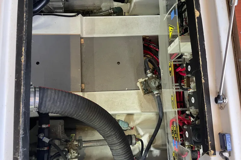 Slide: The Image of Engine compartment of a 2013 Beneteau Swift Trawler 44, showcasing mechanical components and wiring. - 61