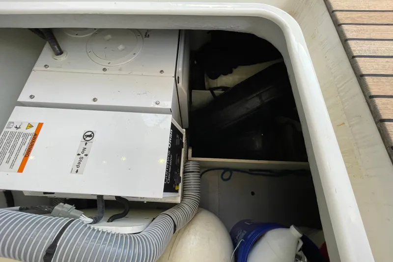 Slide: The Image of Engine compartment of 2013 Beneteau Swift Trawler 44 with visible equipment and storage. - 77