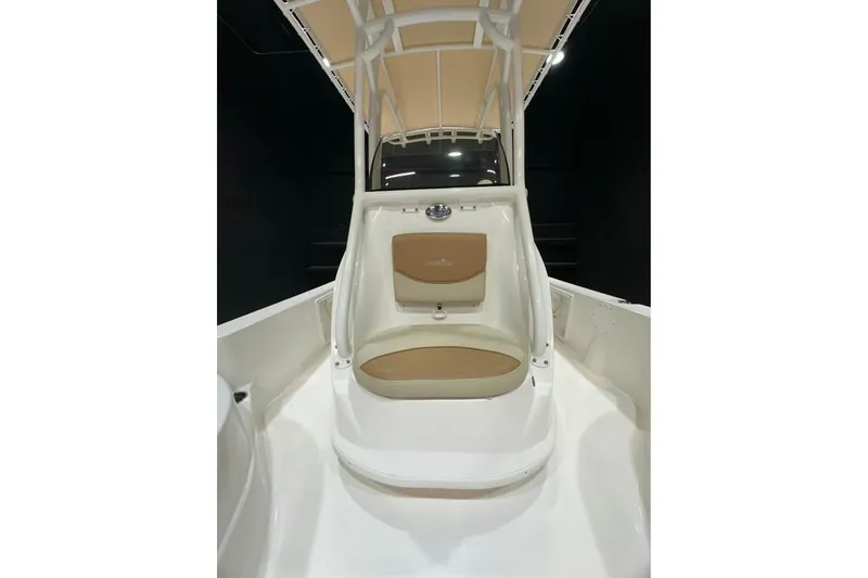 Slide: The Image of 2023 NauticStar 215 XTS boat interior with tan seating and canopy. - 3