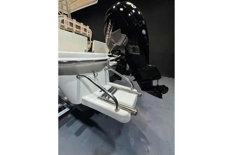 Slide: The Image of 2023 NauticStar 215 XTS boat with Mercury outboard motor and swim ladder. - 5