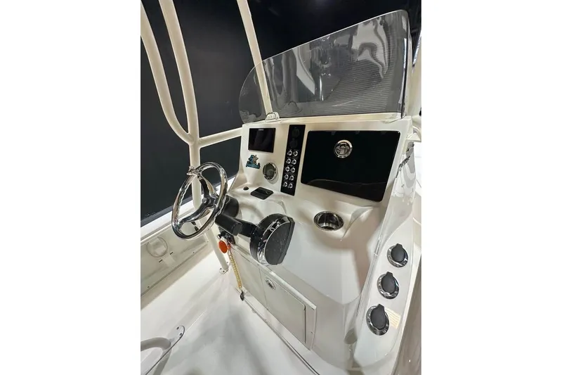 Slide: The Image of 2023 NauticStar 215 XTS boat console with steering wheel and control panel. - 8