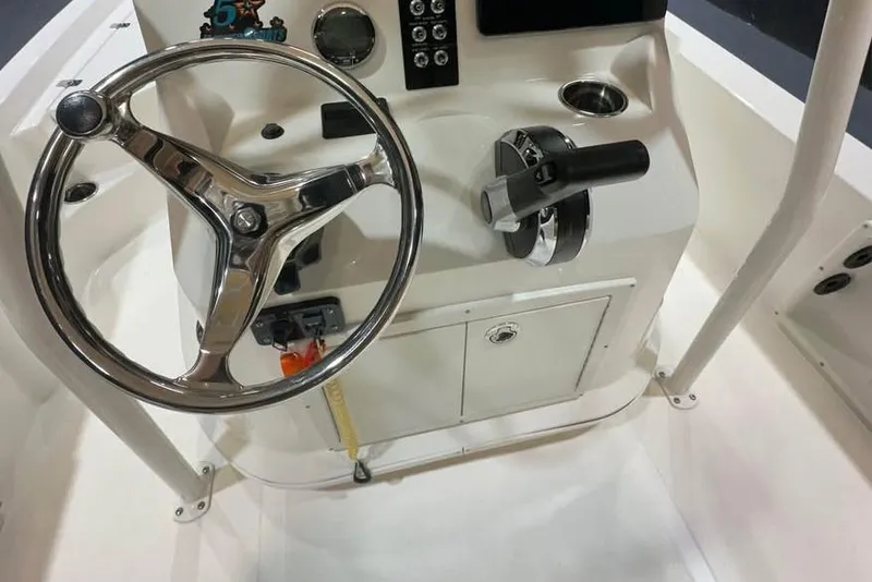 Slide: The Image of 2023 NauticStar 215 XTS boat console with steering wheel and controls. - 9