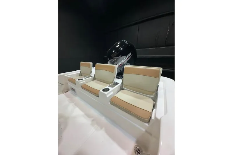 Slide: The Image of 2023 NauticStar 215 XTS boat seats with Mercury engine in a showroom. - 10
