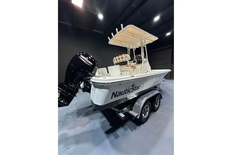 Slide: The Image of 2023 NauticStar 215 XTS boat with Mercury engine on trailer in showroom. - 3