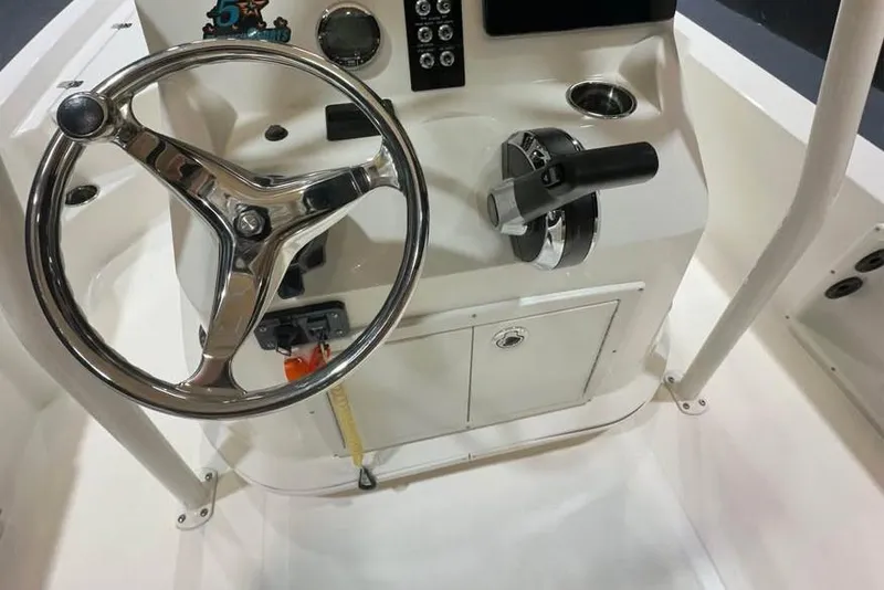 Slide: The Image of 2023 NauticStar 215 XTS boat console with steering wheel and controls. - 7