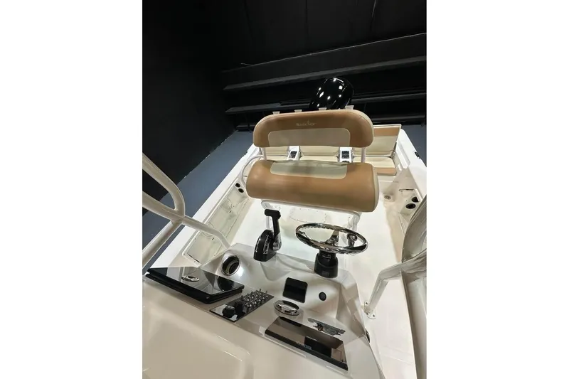 Slide: The Image of 2023 NauticStar 215 XTS boat interior with steering wheel and seating. - 9