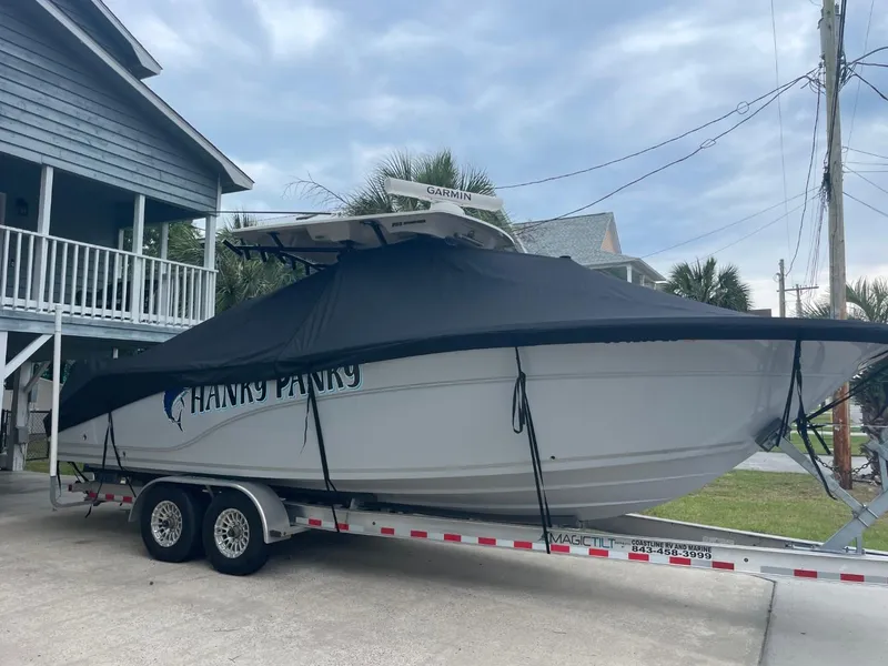 Slide: The Image of 2024 Sea Fox 288 Commander boat on trailer, covered, parked near house. - 1