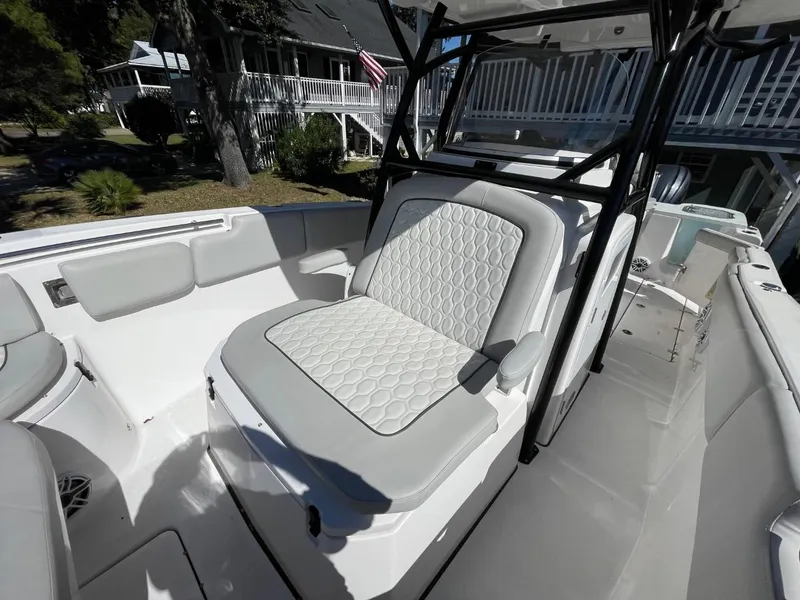 Slide: The Image of 2024 Sea Fox 288 Commander boat interior with cushioned seating and sleek design. - 14