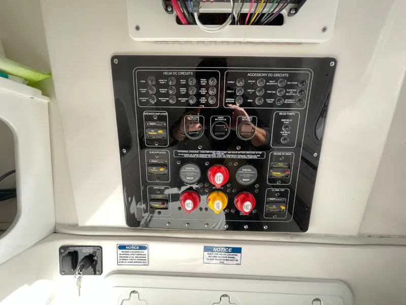 Slide: The Image of Control panel of 2024 Sea Fox 288 Commander boat with various switches and circuit breakers. - 18