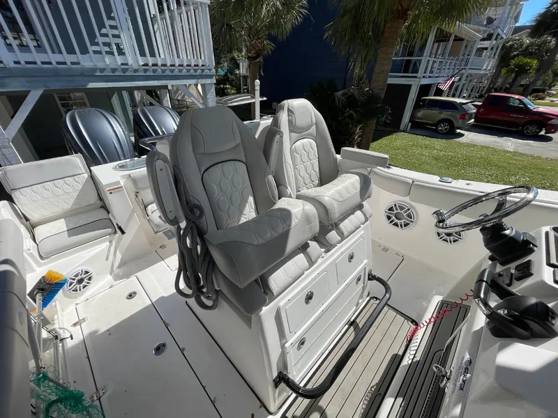 Slide: The Image of 2024 Sea Fox 288 Commander boat interior with dual captain's chairs and steering console. - 22