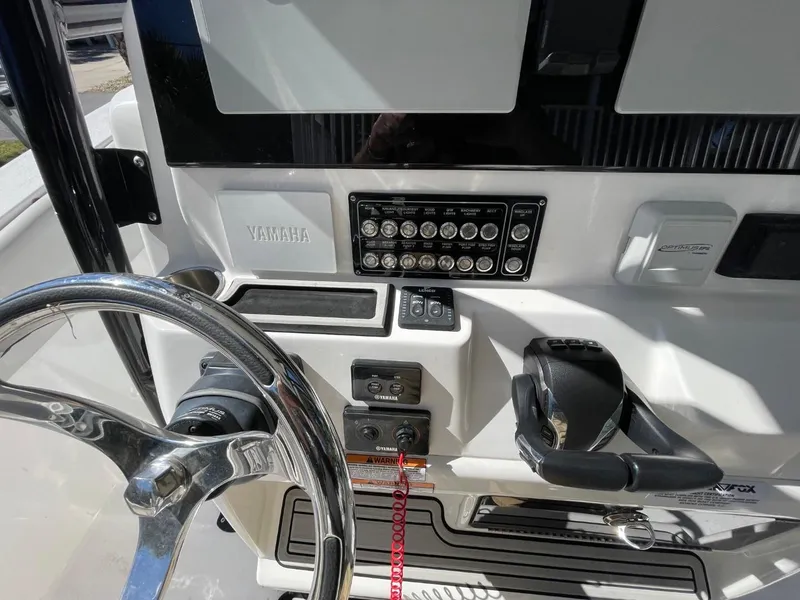 Slide: The Image of 2024 Sea Fox 288 Commander dashboard with steering wheel and control panel. - 26
