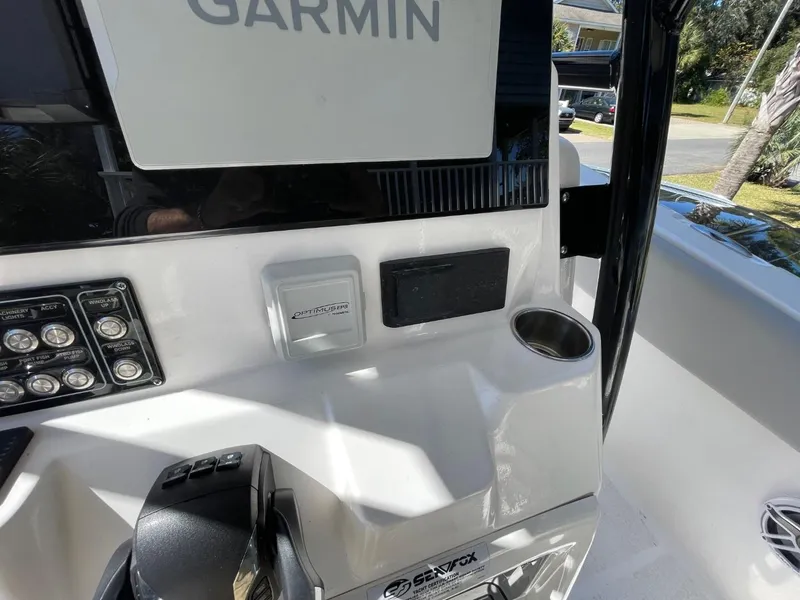 Slide: The Image of 2024 Sea Fox 288 Commander dashboard with Garmin display and controls. - 27