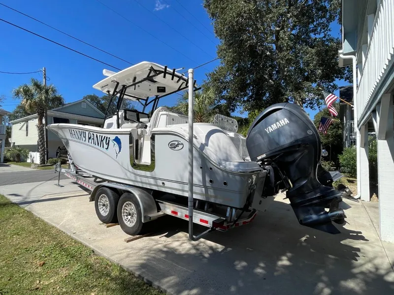 Slide: The Image of 2024 Sea Fox 288 Commander boat on trailer with Yamaha engines, parked outdoors. - 4