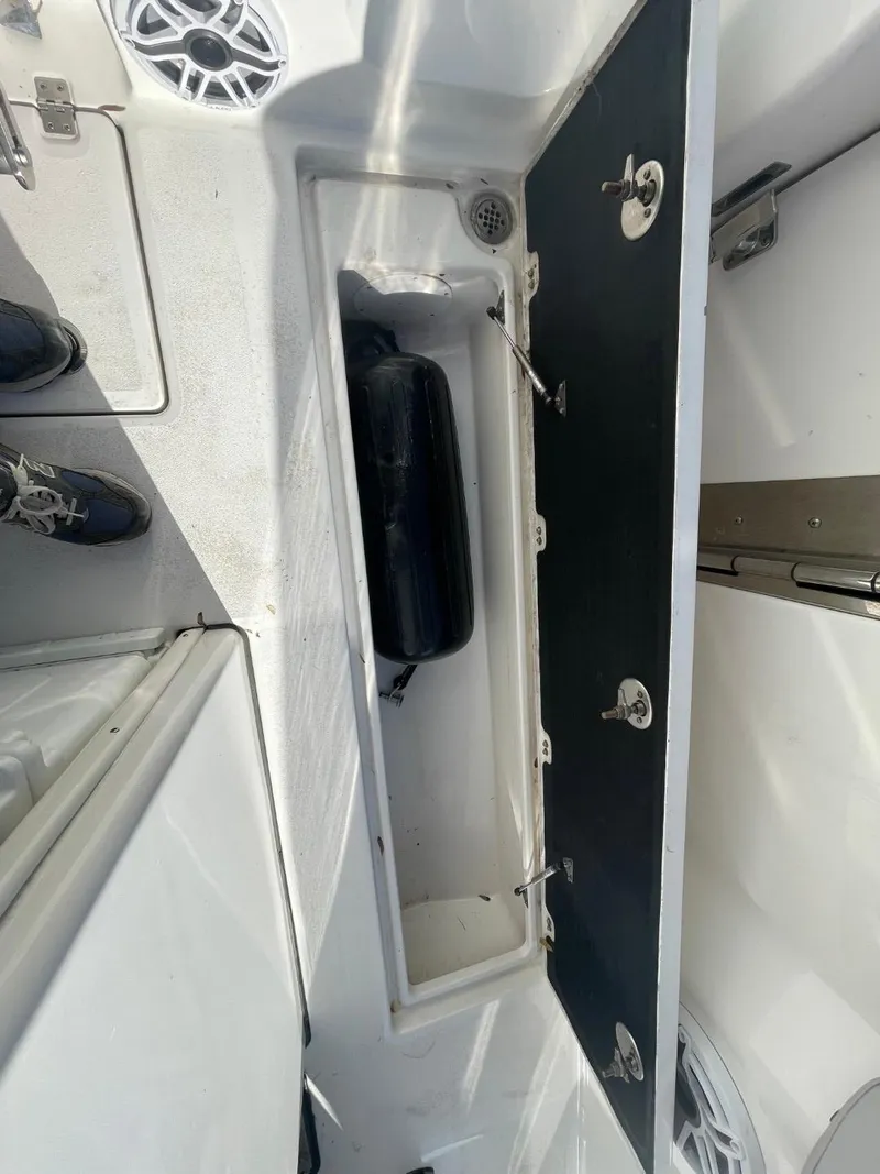 Slide: The Image of 2024 Sea Fox 288 Commander boat storage compartment with open hatch and visible speaker. - 47