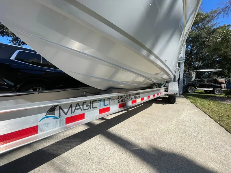 Slide: The Image of 2024 Sea Fox 288 Commander boat on Magic Tilt trailer, parked on concrete driveway. - 49