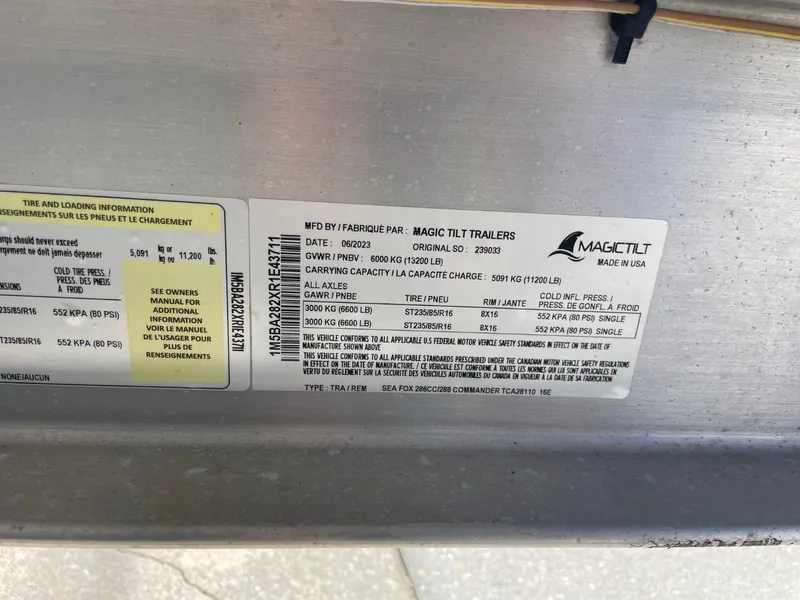 Slide: The Image of Label on Magic Tilt trailer, detailing specifications and load information. - 50