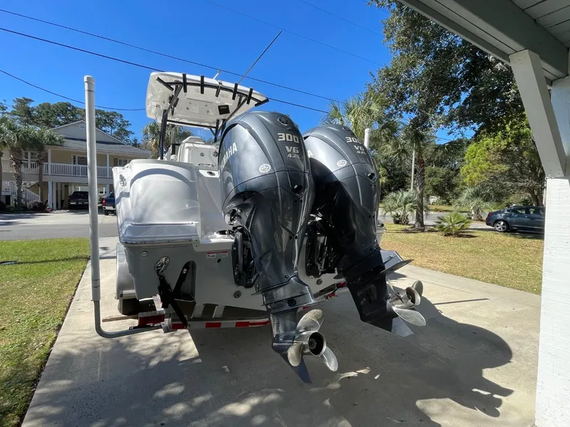 Slide: The Image of 2024 Sea Fox 288 Commander boat with dual Yamaha 300 V6 engines in driveway. - 6