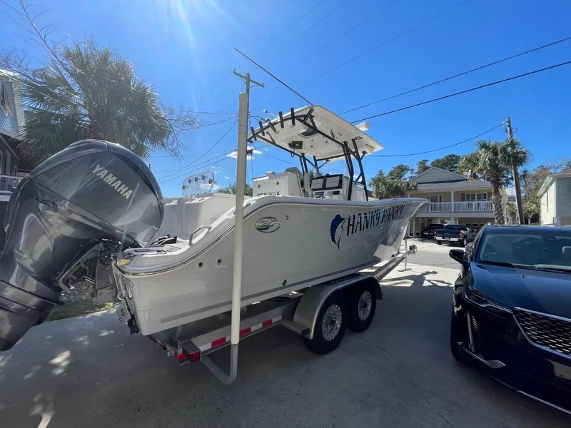 Slide: The Image of 2024 Sea Fox 288 Commander boat on trailer, parked outdoors under clear blue sky. - 8