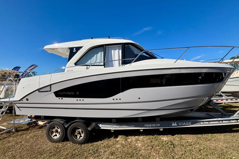 Slide: The Image of 2026 Beneteau Antares 9 V2 boat on trailer under clear blue sky. - 0