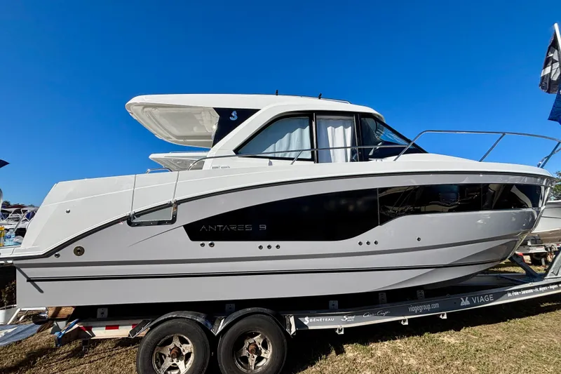 Slide: The Image of 2026 Beneteau Antares 9 V2 boat on trailer under clear blue sky. - 1