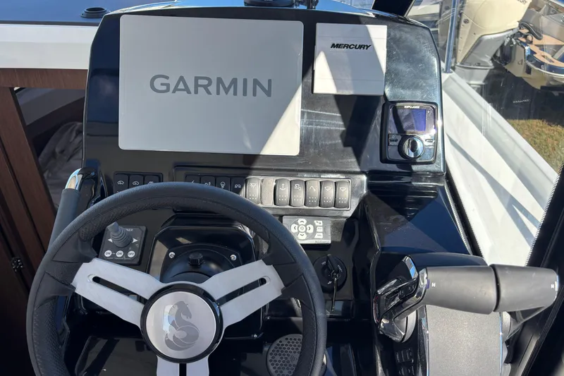 Slide: The Image of 2026 Beneteau Antares 9 V2 helm with Garmin and Mercury controls. - 10