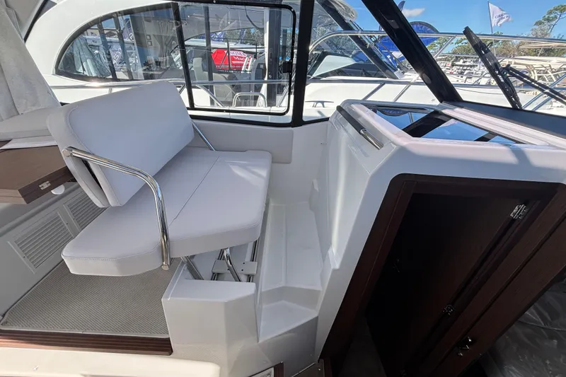 Slide: The Image of Interior of 2026 Beneteau Antares 9 V2 boat, featuring a sleek seating area. - 11