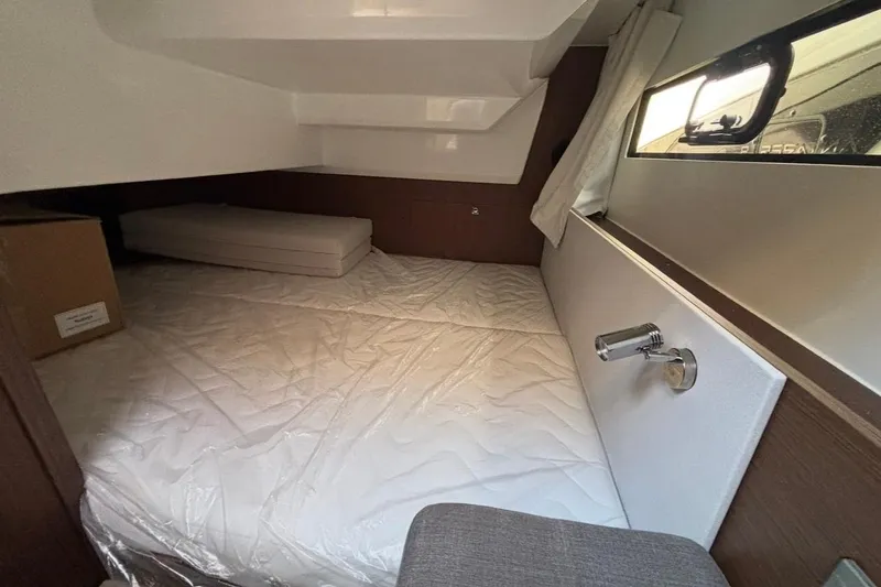 Slide: The Image of Interior cabin of 2026 Beneteau Antares 9 V2, featuring a cozy bed and window. - 15