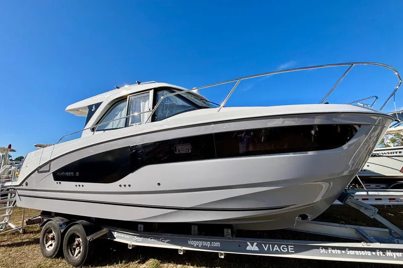 Slide: The Image of 2026 Beneteau Antares 9 V2 boat on trailer under clear blue sky. - 2
