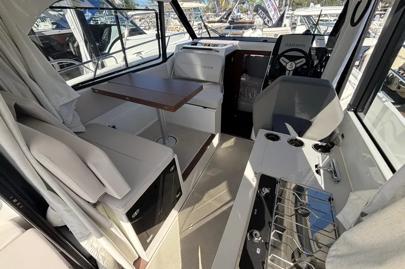 Slide: The Image of Interior of 2026 Beneteau Antares 9 V2 boat, featuring seating, table, and helm. - 5