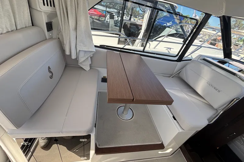 Slide: The Image of Interior of 2026 Beneteau Antares 9 V2, featuring elegant seating and wooden table. - 6