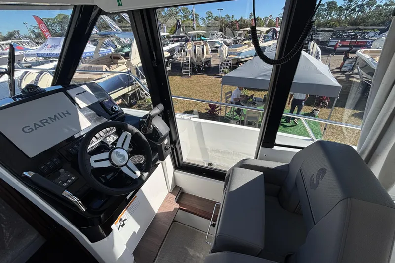Slide: The Image of Interior view of 2026 Beneteau Antares 9 V2 boat with Garmin navigation system. - 9