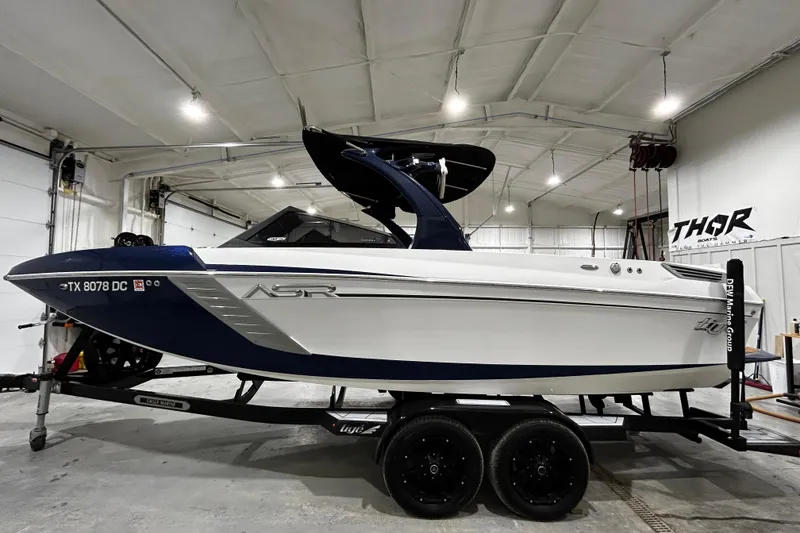 The Image of 2015 Tigé ASR boat in a garage, featuring sleek design and modern features. - 1