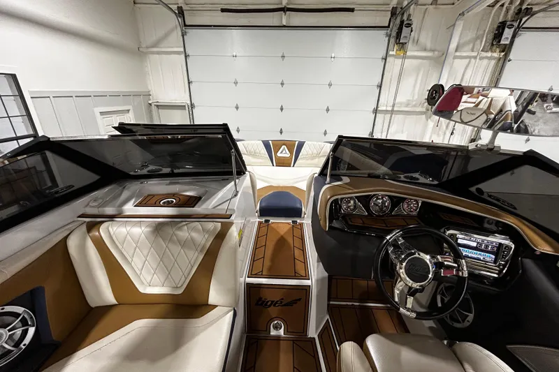 Slide: The Image of 2015 Tigé ASR boat interior with luxurious seating and modern dashboard design. - 12